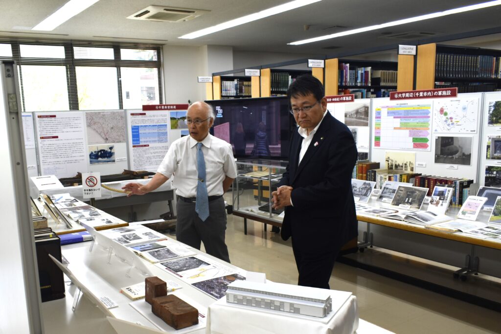 図書館内の企画展示をご覧になる神谷市長と、佐久間理事長の画像